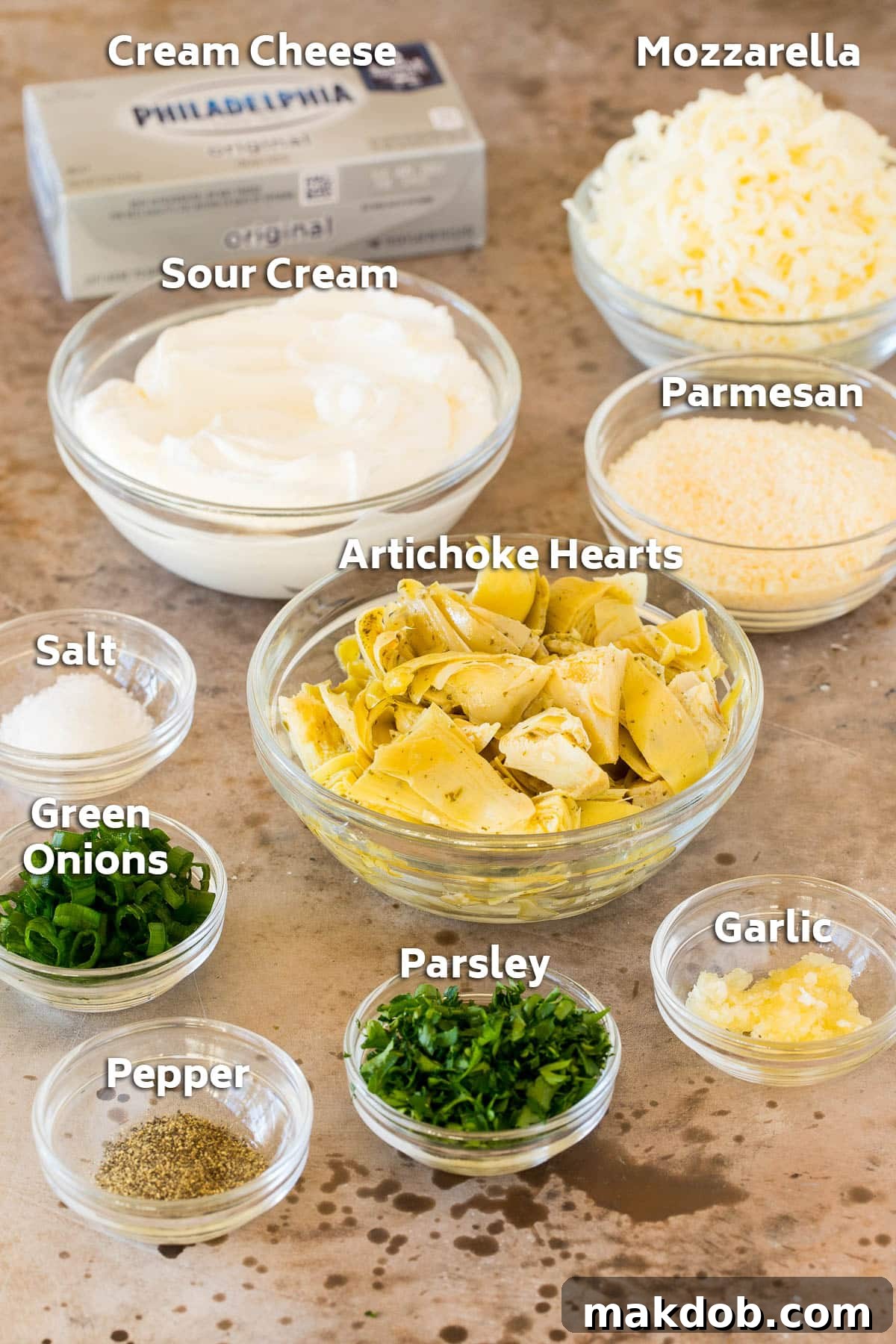 Irresistible Artichoke Dip 3 Bowls of ingredients including artichoke hearts, cheese, herbs and seasonings.