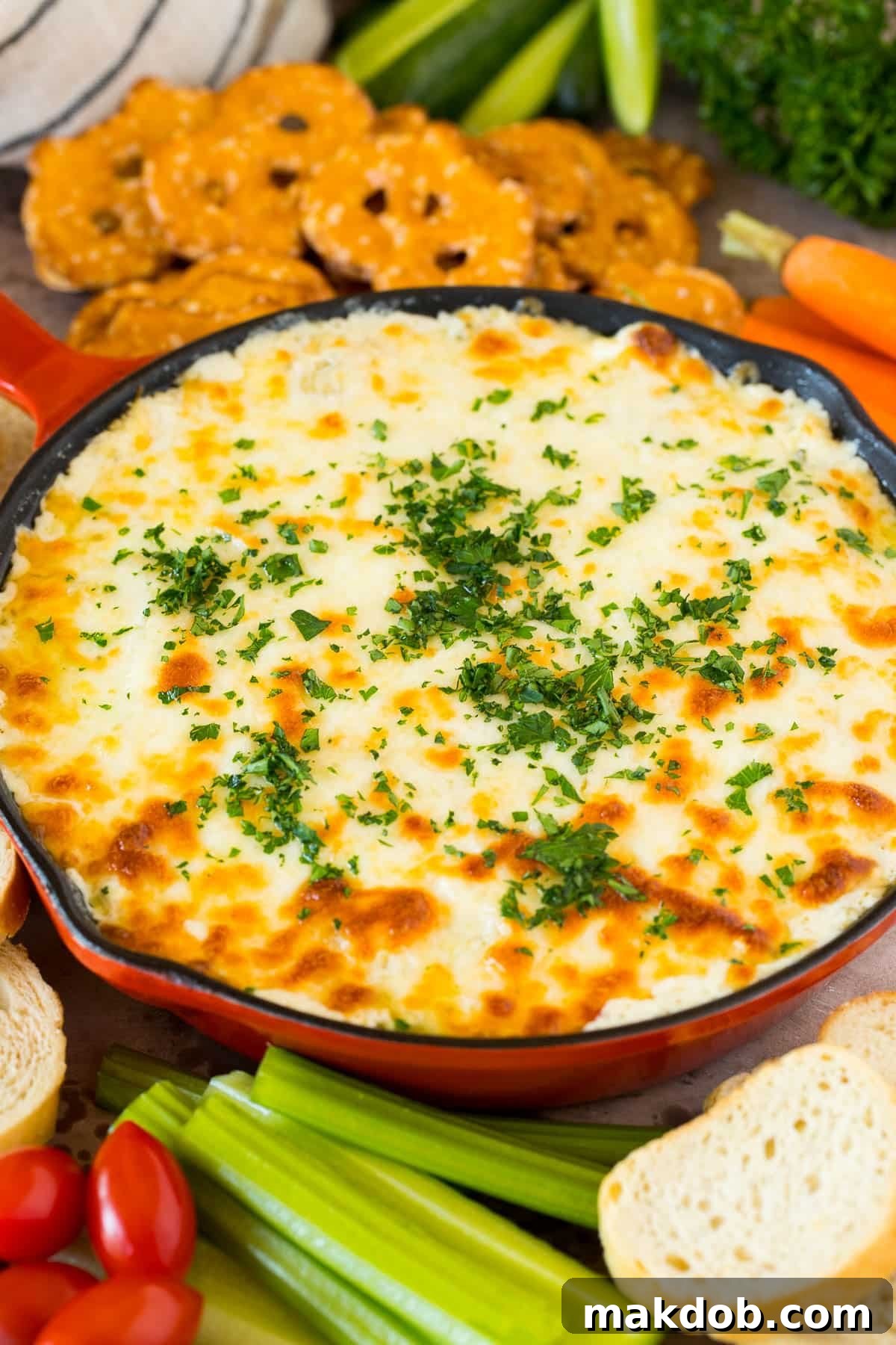 Irresistible Artichoke Dip 5 A pan of creamy dip with cheese melted on top.