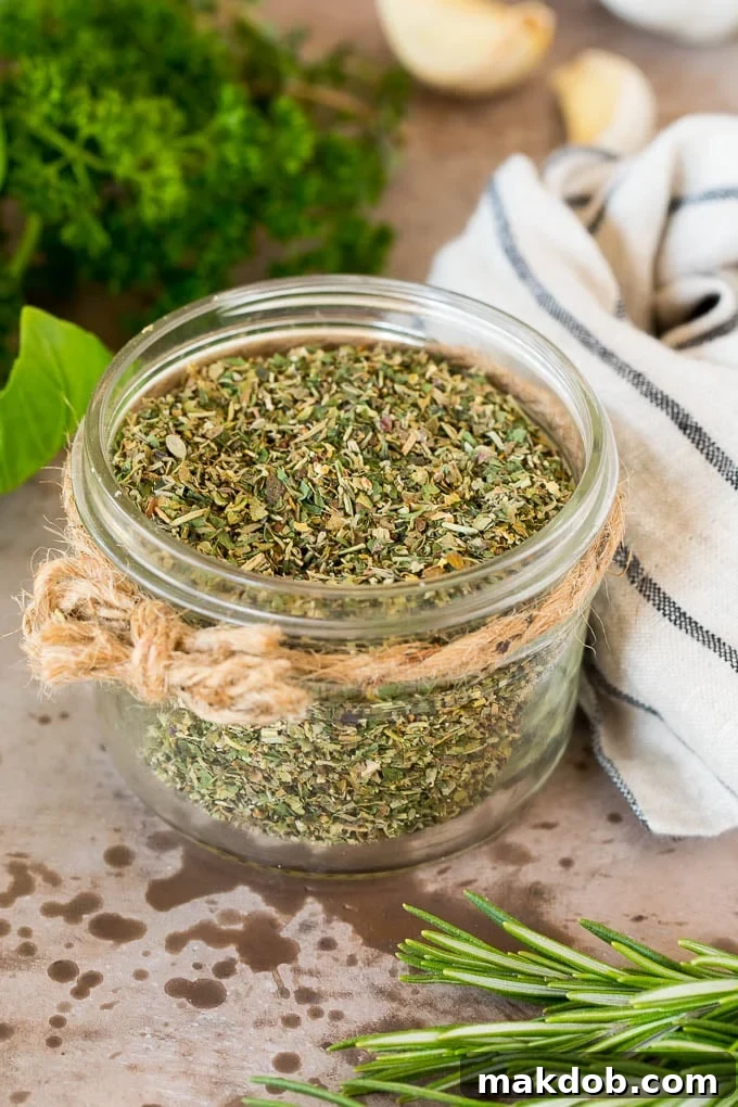 Homemade Italian Herb Blend 2 A jar of homemade Italian seasoning surrounded by fresh herbs.