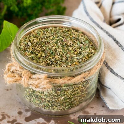 Homemade Italian Herb Blend 3 A jar of homemade Italian seasoning surrounded by fresh herbs.