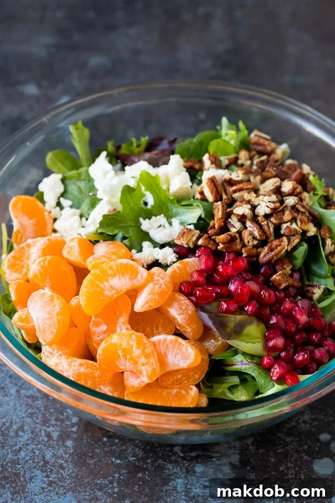 Greens topped with fruit, feta cheese and candied pecans, awaiting dressing.