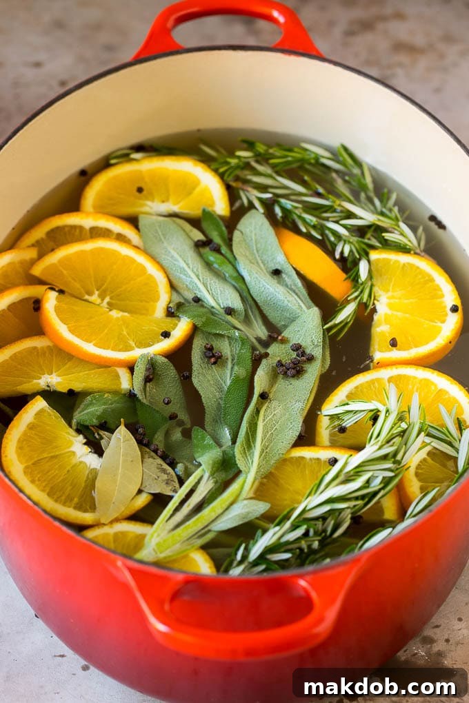 This is a complete guide on how to brine a turkey to get the most tender and flavorful bird each and every time. A pot of liquid with oranges, herbs and peppercorns.