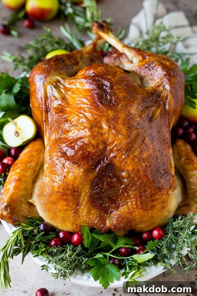 This is a complete guide on how to brine a turkey to get the most tender and flavorful bird each and every time. Learn how to brine a turkey to make this cooked turkey garnished with herbs.
