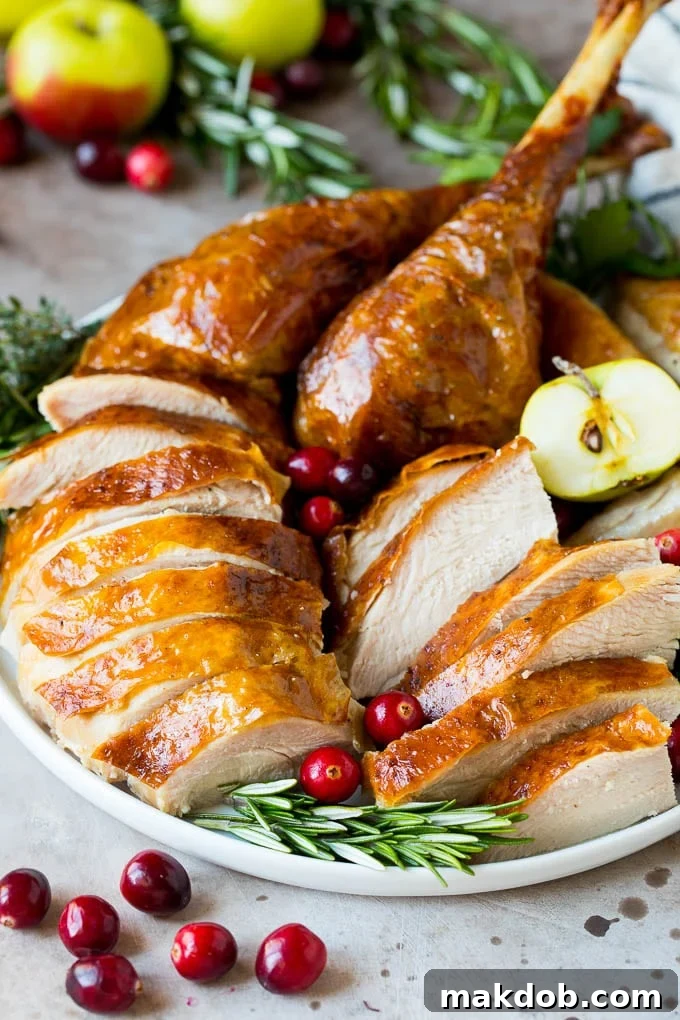 This is a complete guide on how to brine a turkey to get the most tender and flavorful bird each and every time. Sliced turkey on a serving plate.