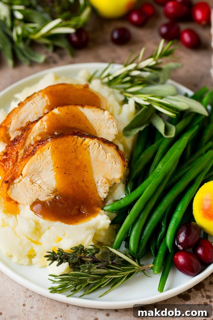 Instant Pot turkey breast sliced and served with creamy mashed potatoes and homemade gravy.