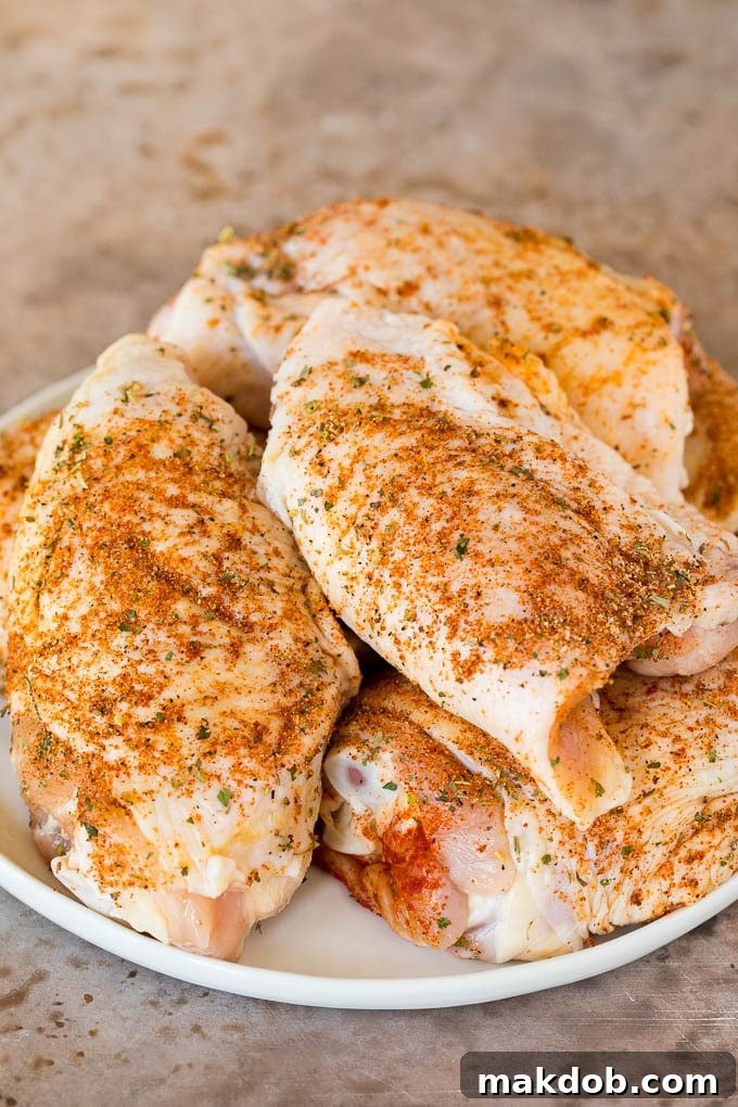 Chicken coated in a spice mixture, ready for searing in the Instant Pot.