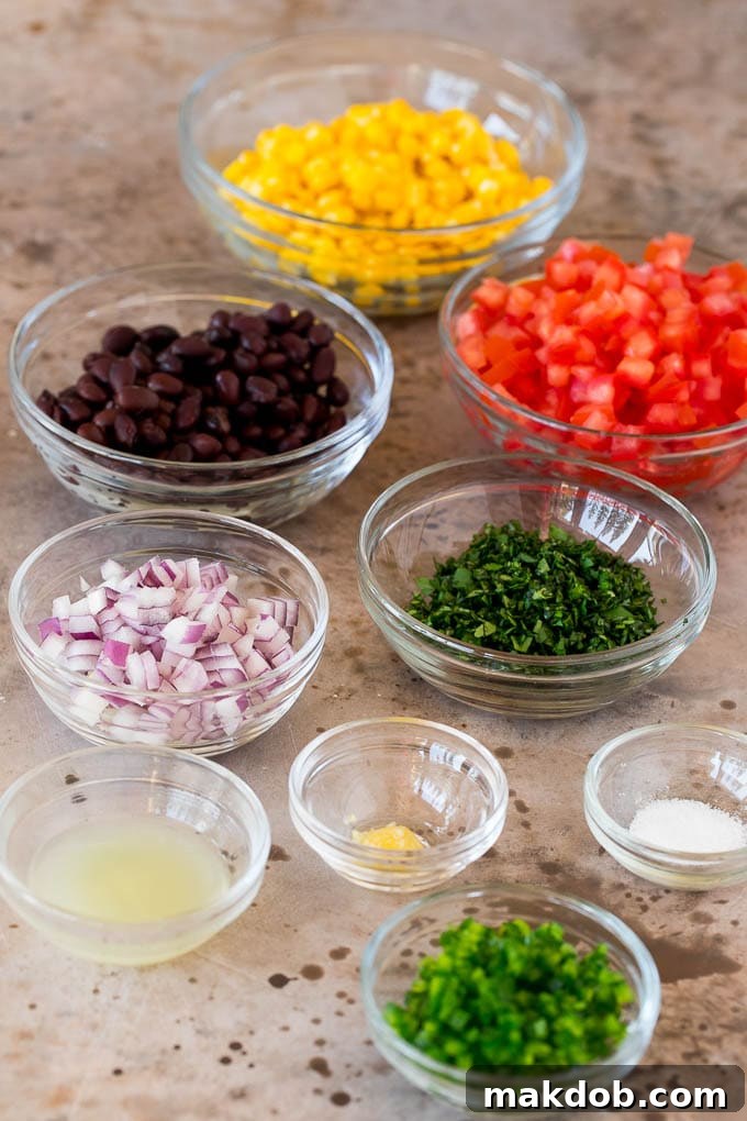 Bowls of ingredients including cilantro, corn, beans and tomatoes.