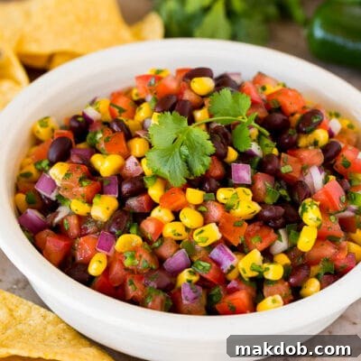 A bowl of black bean and corn salsa with tortilla chips.