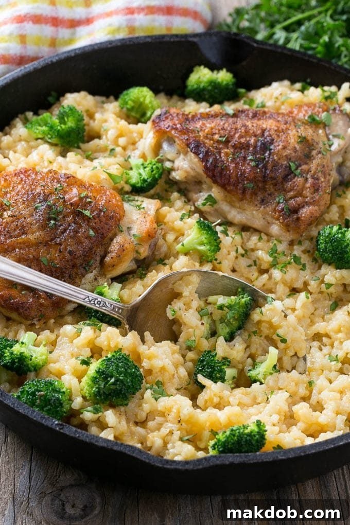 A serving spoon in chicken and rice casserole.