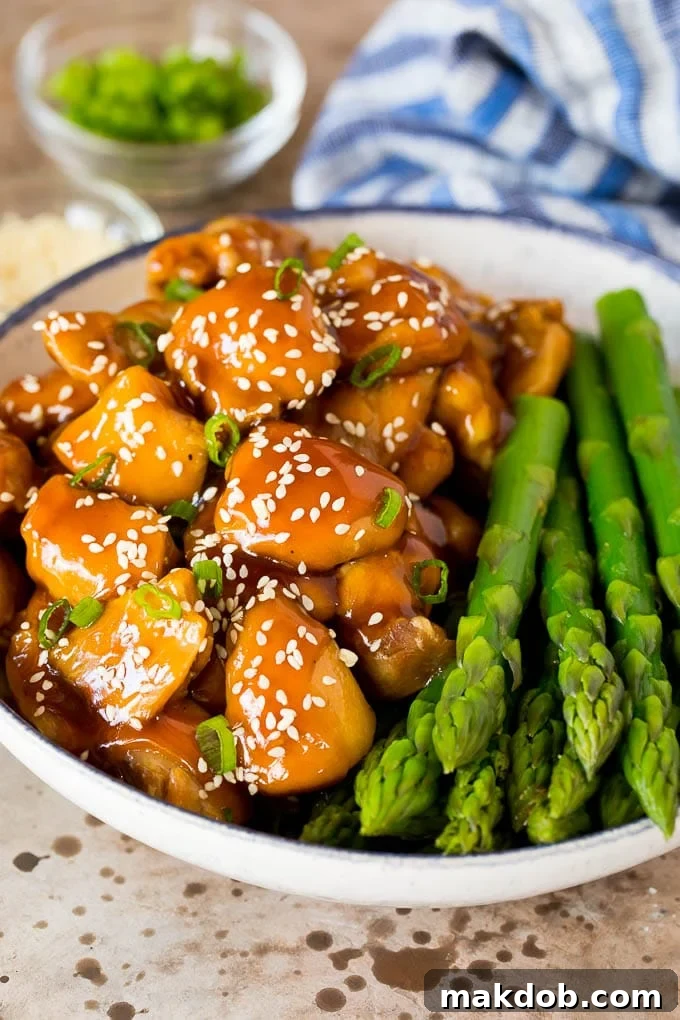 Delicious Instant Pot teriyaki chicken served with asparagus, a perfect quick and easy family meal. Instant Pot teriyaki chicken served with asparagus, garnished with sesame seeds and green onions.