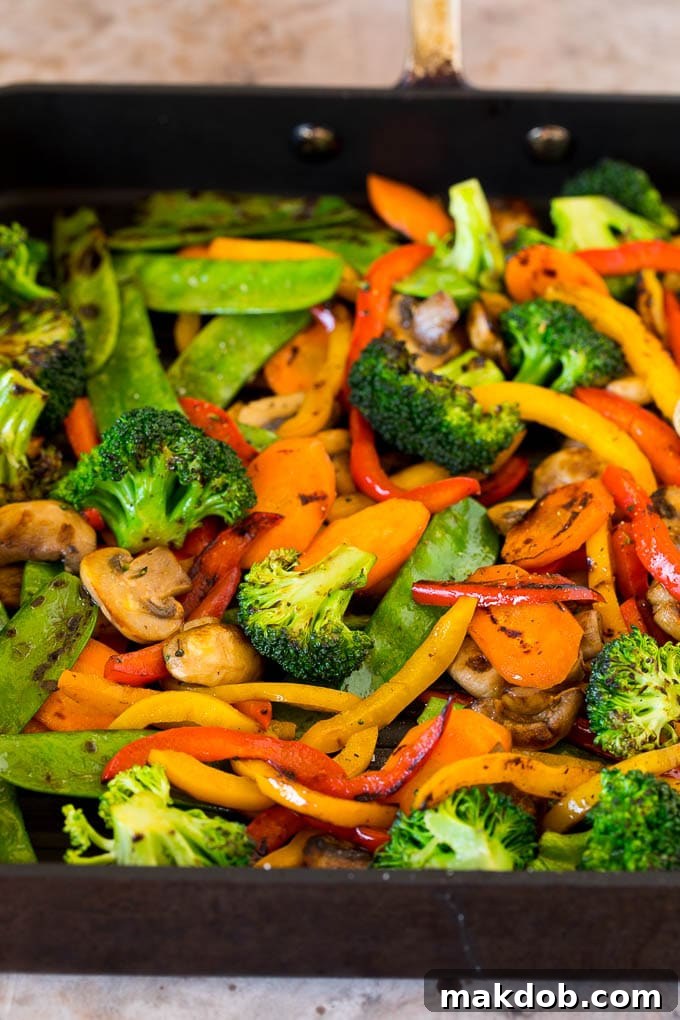 Cooked vibrant vegetables on a grill pan, lightly charred and ready for a teriyaki bowl.
