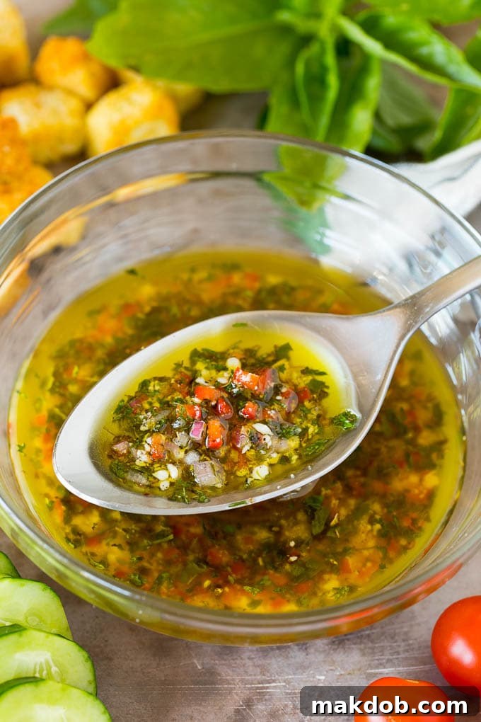 Zesty Homemade Italian Dressing with Fresh Herbs A beautifully presented bowl of homemade Italian dressing with a spoon, ready to serve.