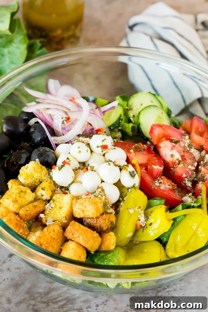 Fresh Salad with Homemade Italian Dressing A fresh garden salad generously drizzled with homemade Italian dressing, showcasing its appetizing appeal.