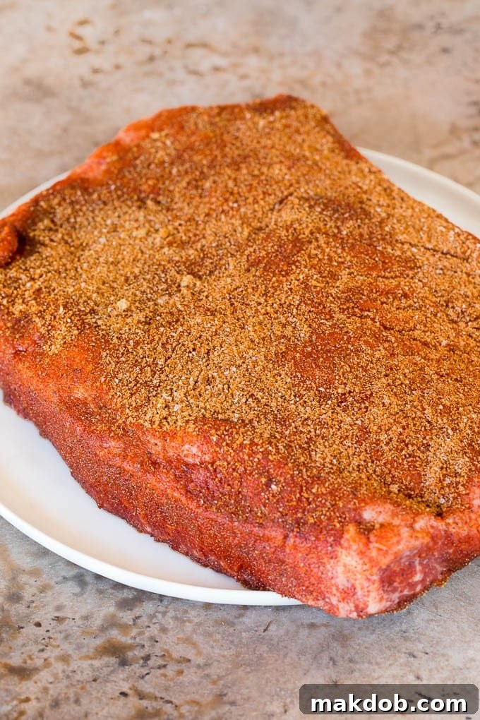 A brisket coated in BBQ spice rub.