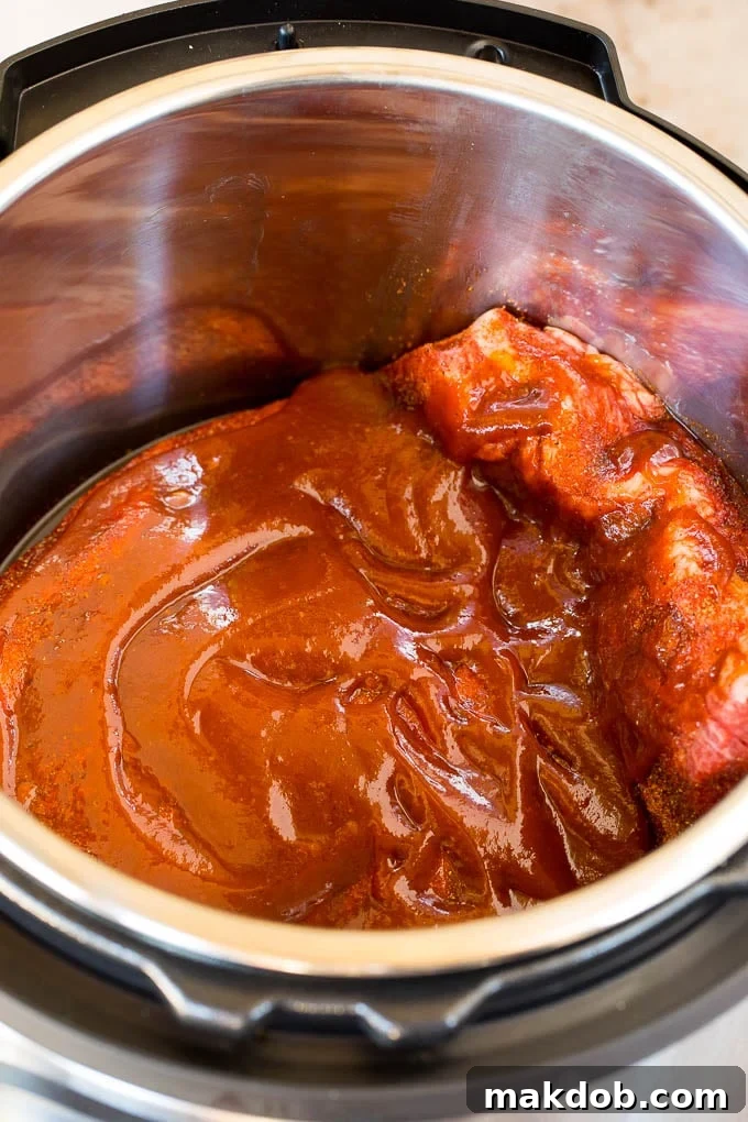 Brisket in a pressure cooker covered in sauce.