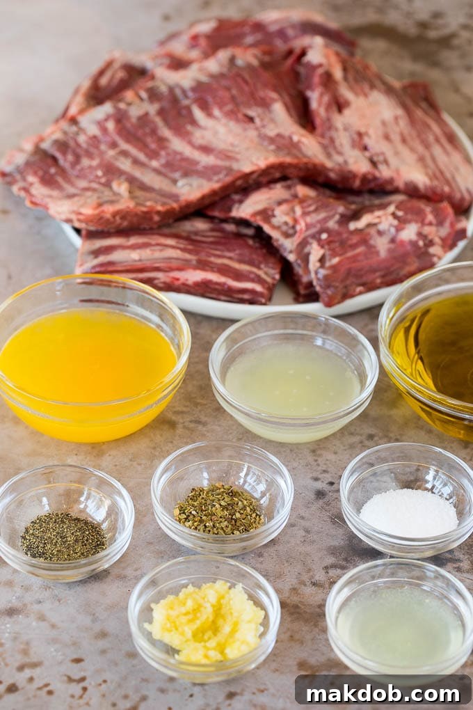 Bowls of marinade ingredients and a plate of raw skirt steak ready for preparation.