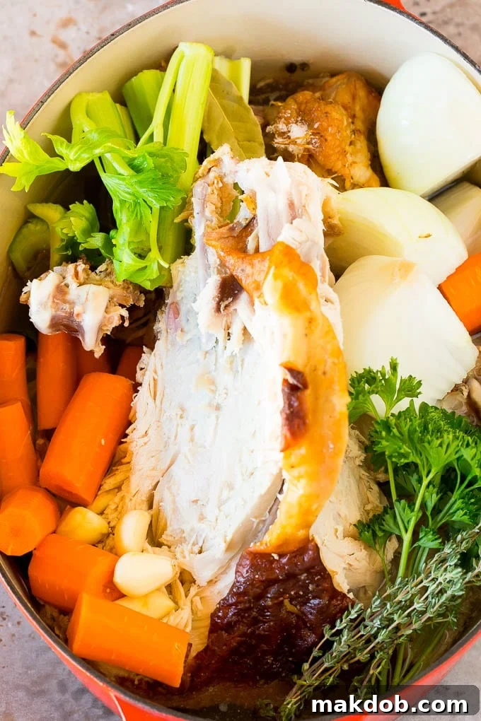 A turkey carcass and vegetables in a large stockpot, simmering to create homemade broth.