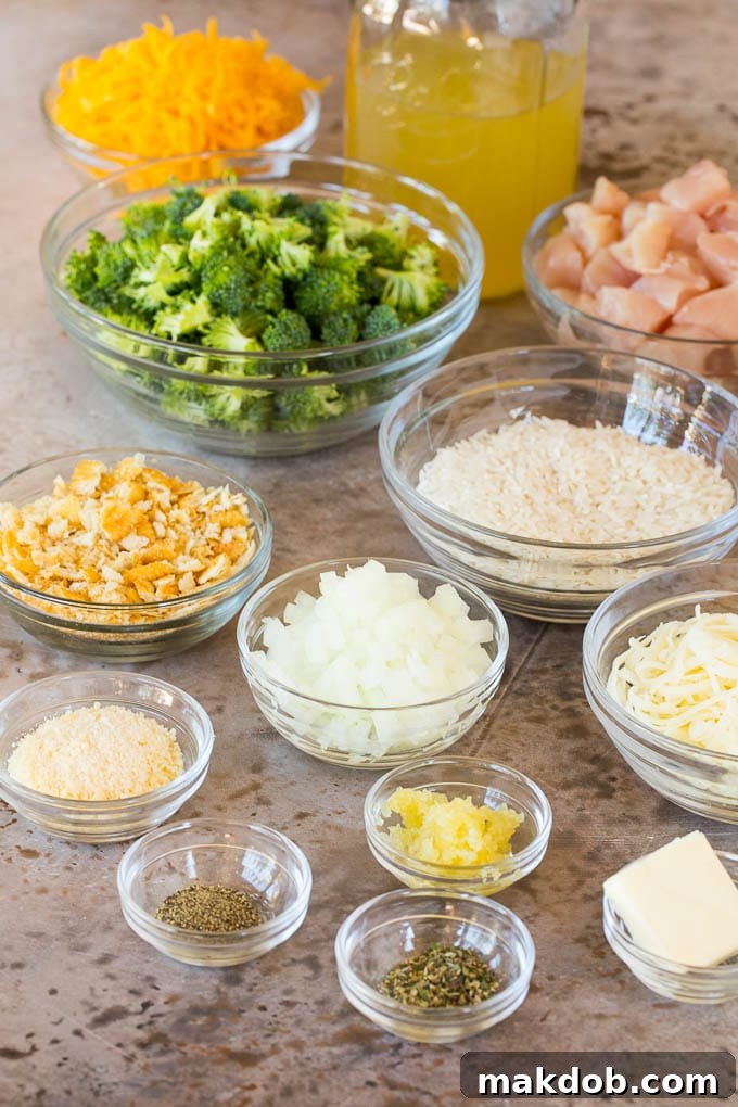 Bowls of ingredients including chicken, rice, cheeses and broccoli.
