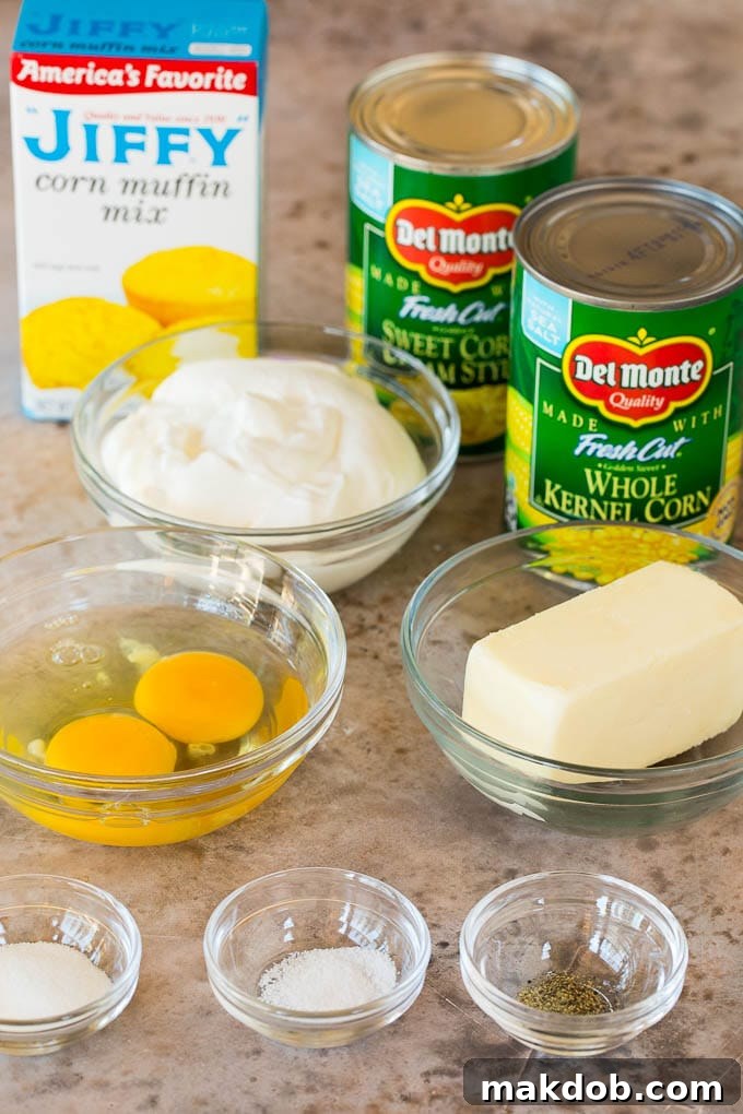 This cornbread casserole is a blend of corn muffin mix, canned corn, creamed corn, seasoning, eggs and butter, all baked together to make a hearty side dish. Bowls of ingredients with cans of corn and a box of corn muffin mix.