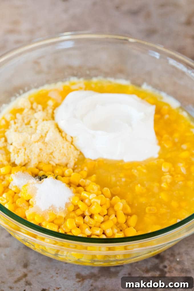 Corn, sour cream, corn muffin mix and sugar in a bowl.