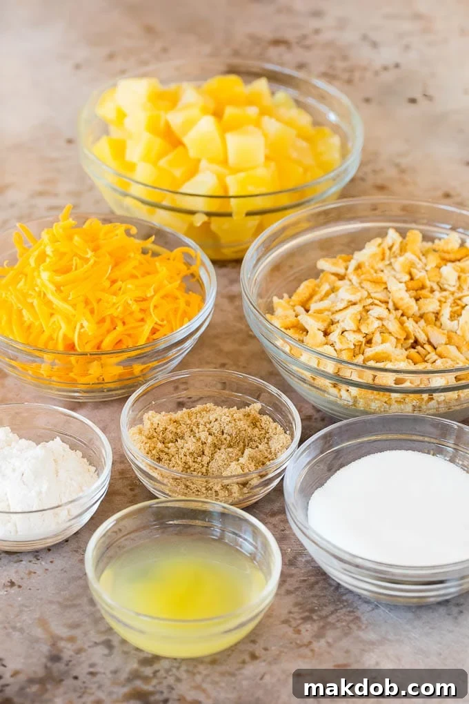 Bowls of pineapple, sugar, crackers and cheese.