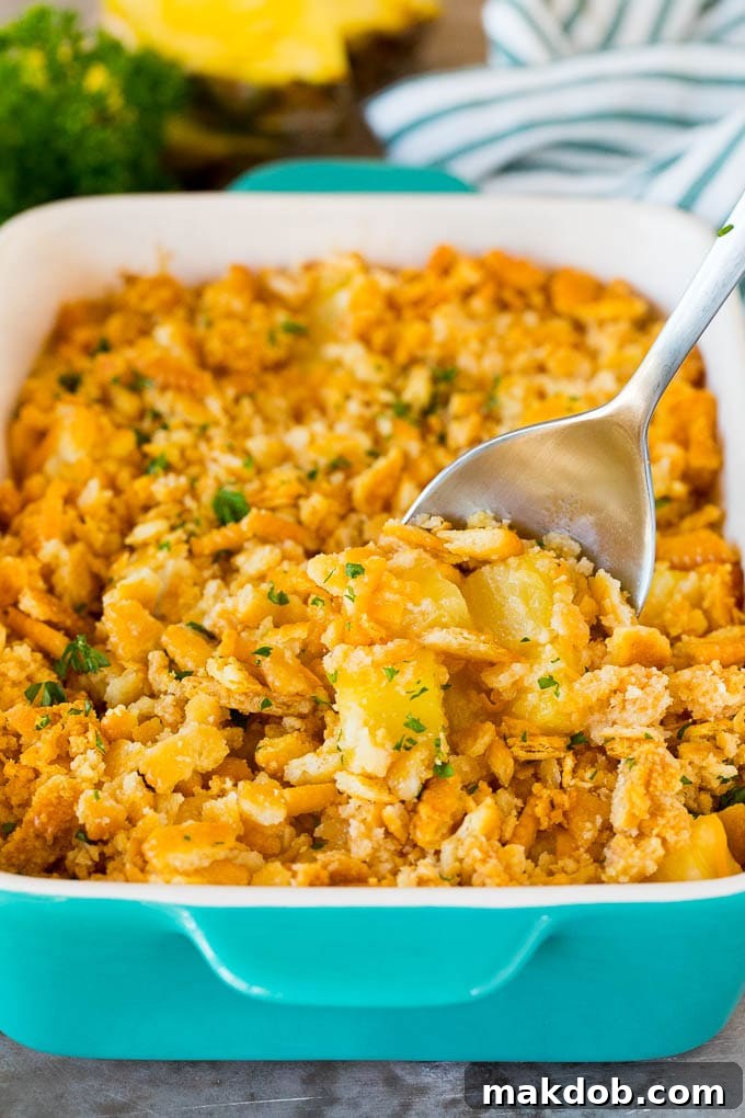 A serving spoon in a dish of pineapple casserole.