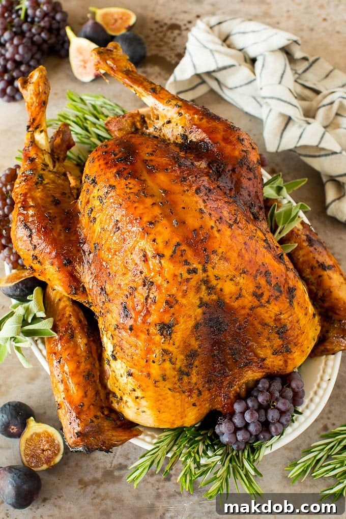 Cooked Turkey with Marinade Turkey marinade over a cooked turkey, garnished with herbs and grapes.