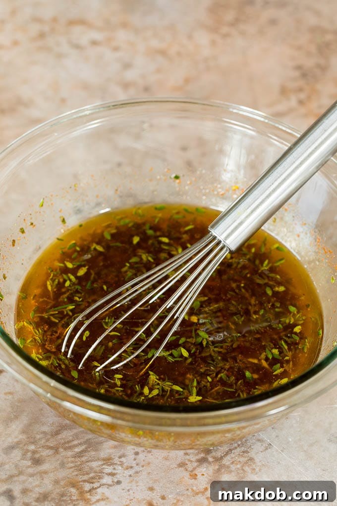 Marinade Mixture A bowl of olive oil mixed with soy sauce, garlic and seasonings.