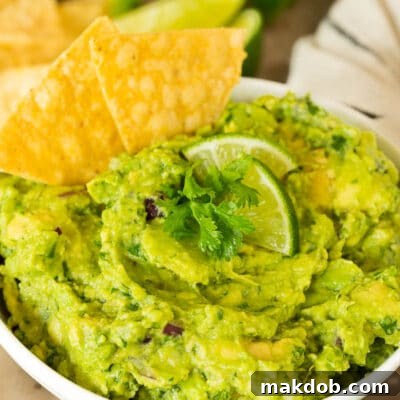 Copycat Chipotle Guacamole 7 A bowl of Chipotle guacamole with chips.