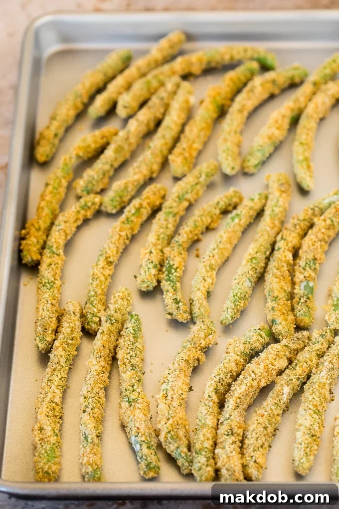 Breaded green beans on a sheet pan.