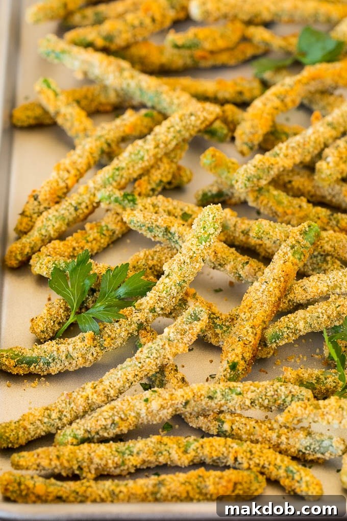 A pan of green bean fries garnished with parsley.