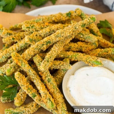 A plate of green bean fries served with parsley and ranch.