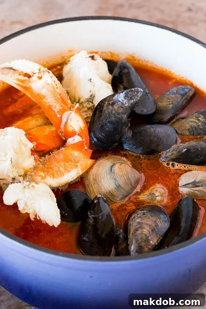 Crab, mussels and clams in a pot of tomato broth.