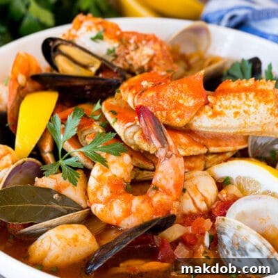 A large bowl of cioppino with crab, shrimp and shellfish.