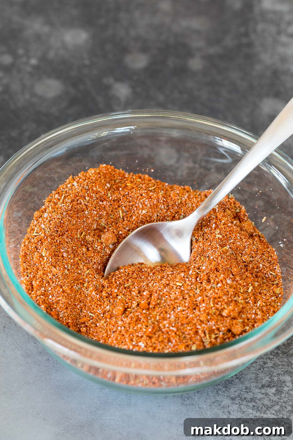 Signature Salmon Seasoning Blend 5 A bowl of seasoning mixed together with a spoon in it.