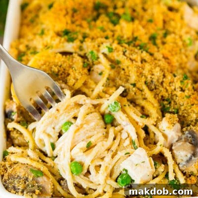 Creamy Turkey Tetrazzini Bake 2 A fork serving up a portion of turkey tetrazzini.