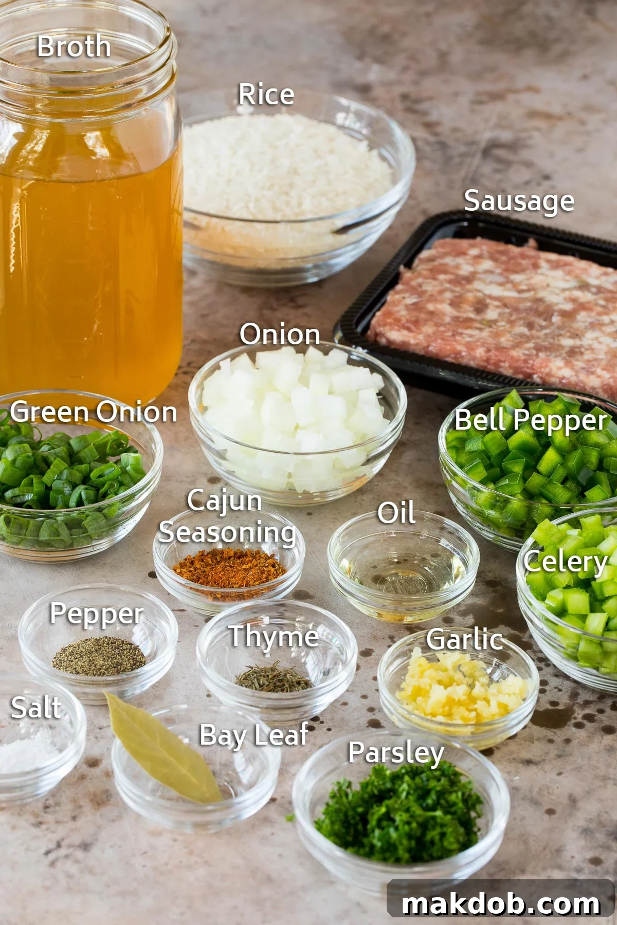 Savory Cajun Dirty Rice 3 Bowls of ingredients including vegetables and seasonings and rice, as well as a container of sausage and jar of broth.