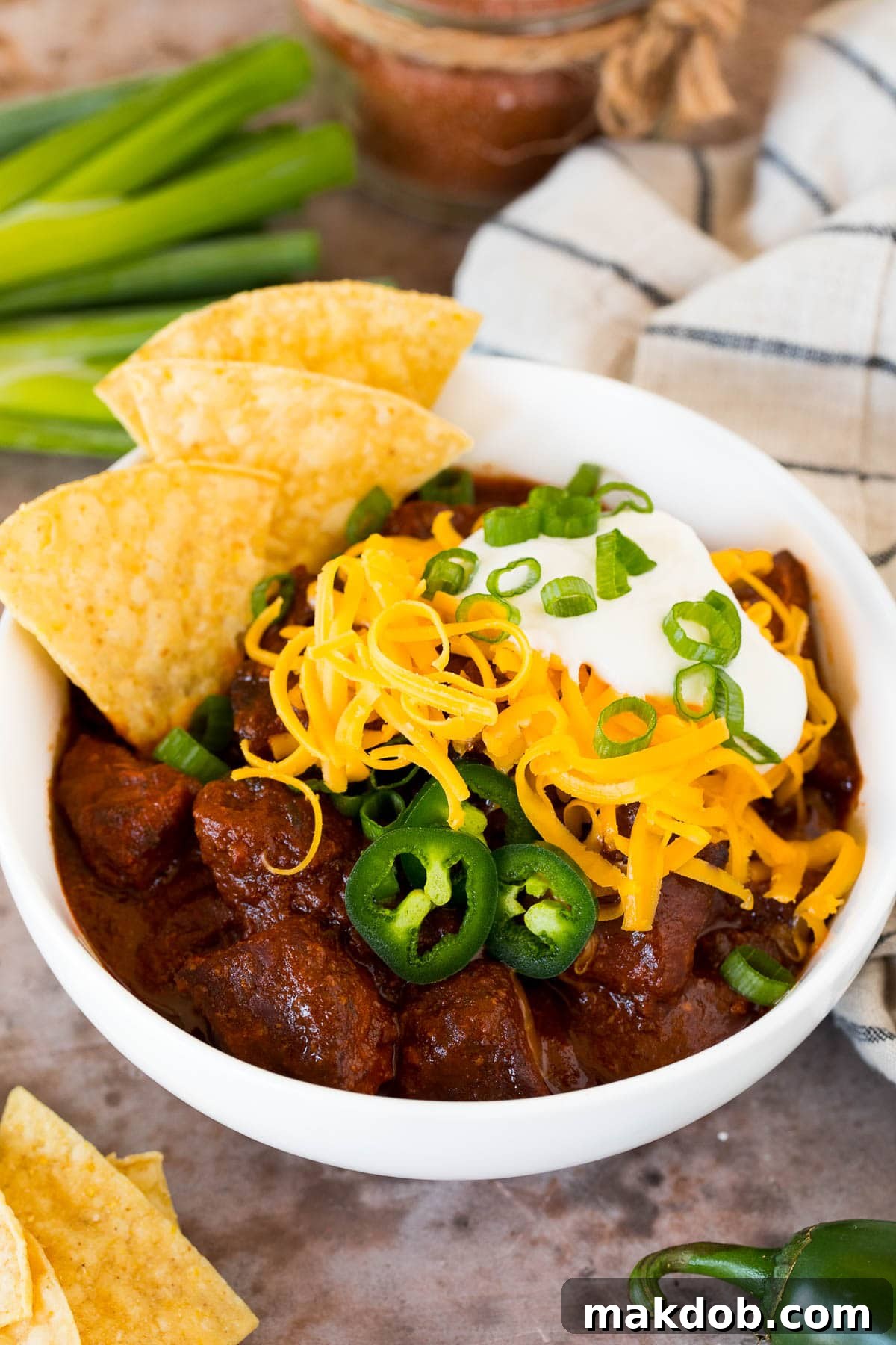 A bowl of Texas chili made with chili seasoning, garnished with fresh cilantro.