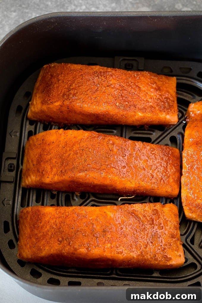 This air fryer salmon is fresh fish fillets topped with a homemade spice rub, then cooked to golden brown perfection. Spice crusted salmon fillets in an air fryer.