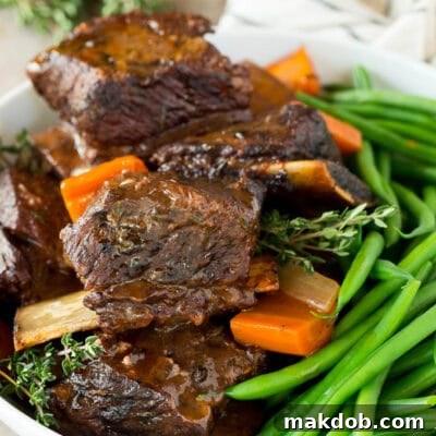 Fall-Off-The-Bone Slow Cooker Short Ribs 7 A serving bowl of slow cooker short ribs and green beans.
