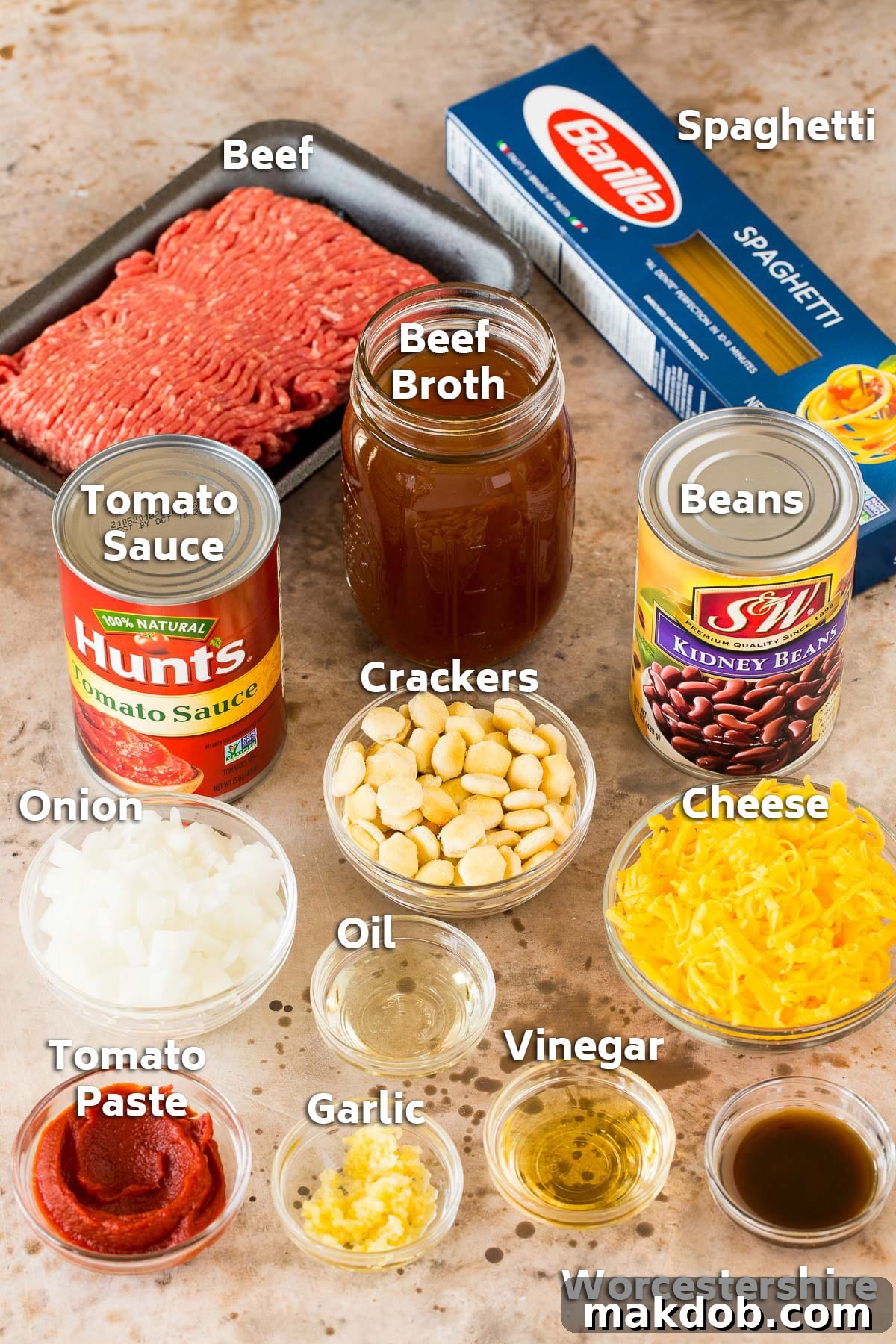 A vibrant selection of meat, spaghetti, assorted seasonings, and kidney beans, all essential ingredients for an authentic Cincinnati chili.