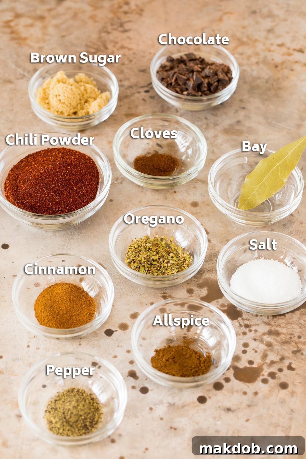 Small bowls filled with the diverse blend of spices and seasonings required to create the authentic flavor of Cincinnati chili.