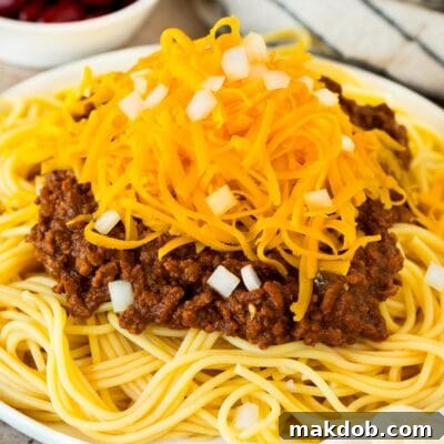 Cincinnati chili served over spaghetti with cheese and onions.