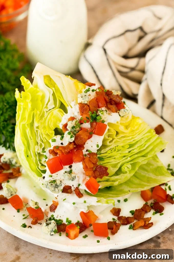 Crisp Wedge Salad with Blue Cheese 2 A wedge salad topped with bacon, tomatoes and cheese.