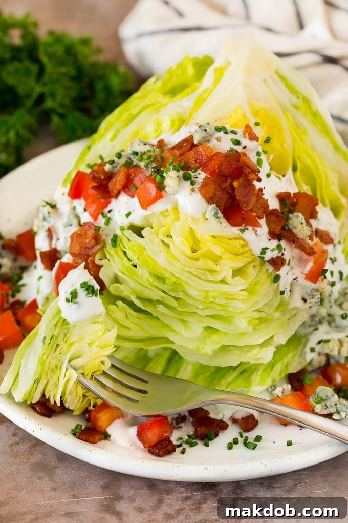 Crisp Wedge Salad with Blue Cheese 6 A fork that has cut into a wedge salad.