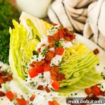 Crisp Wedge Salad with Blue Cheese 7 A wedge salad topped with bacon, tomatoes and cheese.