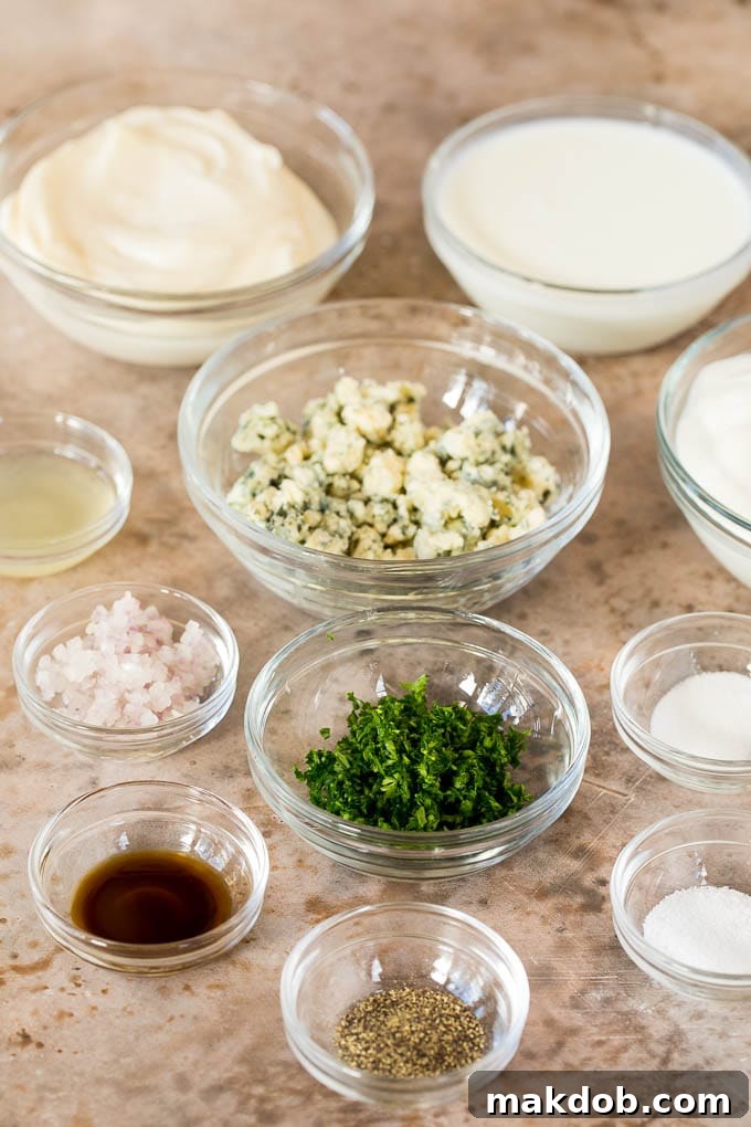 Bowls of sour cream, buttermilk, mayonnaise, blue cheese, and various seasonings arranged before mixing.
