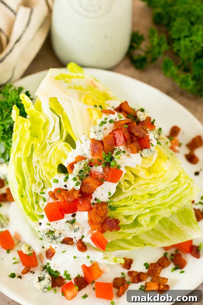 A vibrant wedge salad generously topped with homemade blue cheese dressing, ready to be served.