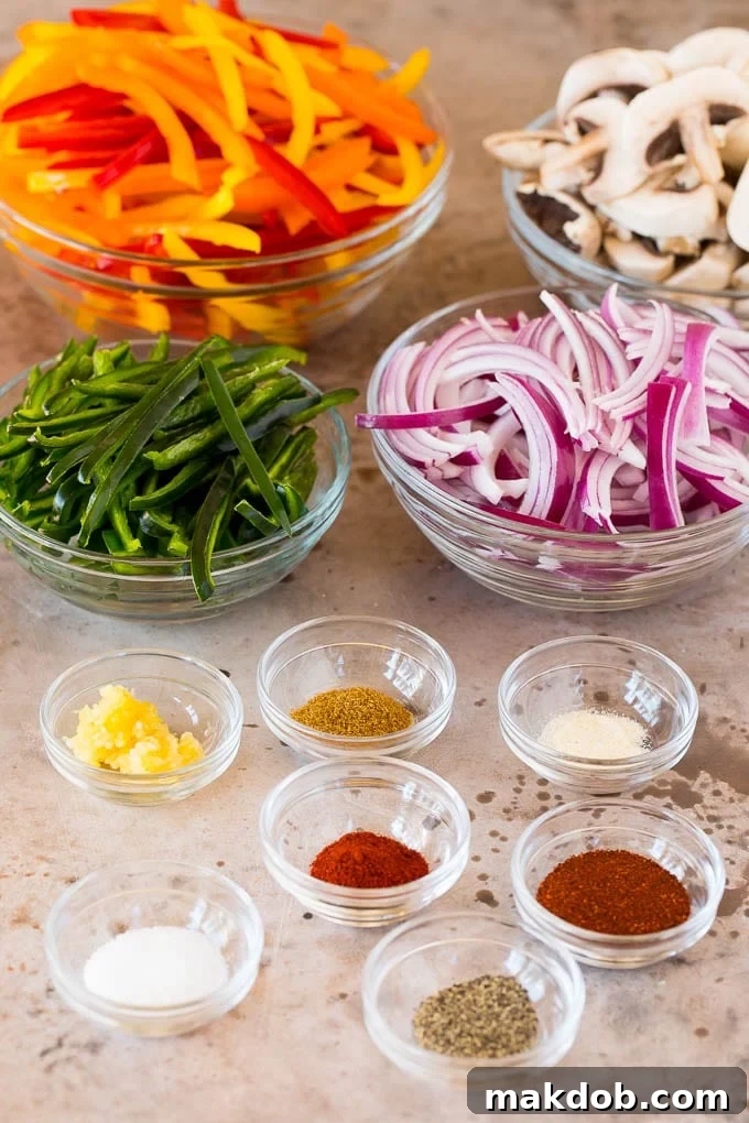 Bowls filled with freshly sliced and seasoned vegetables, including colorful bell peppers, poblano peppers, mushrooms, and red onions, ready for cooking into vegetarian fajitas.