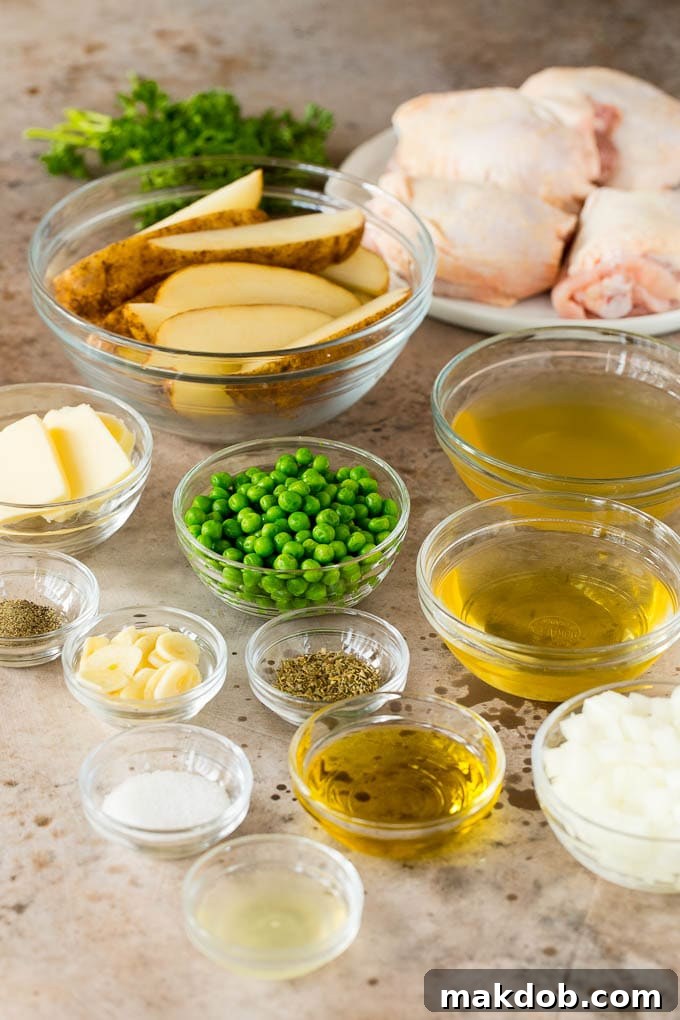 Bowls of chicken, potatoes, peas and sauce ingredients, prepared for cooking Chicken Vesuvio.